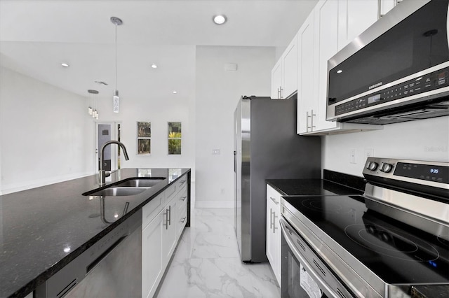 kitchen with white cabinetry, appliances with stainless steel finishes, sink, and pendant lighting