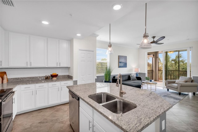 kitchen featuring sink, pendant lighting, white cabinets, and appliances with stainless steel finishes