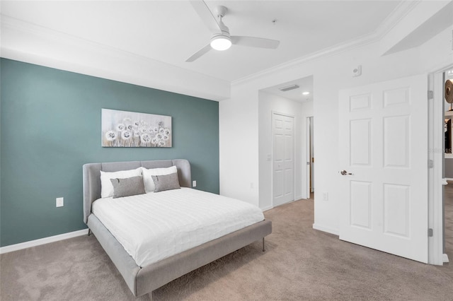 carpeted bedroom featuring ornamental molding and ceiling fan