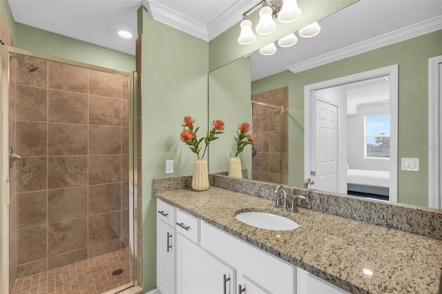 bathroom featuring a shower with door, crown molding, and vanity