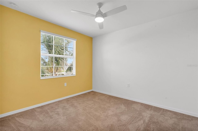 unfurnished room with ceiling fan and light carpet