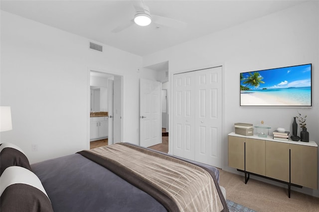 carpeted bedroom featuring ceiling fan and a closet