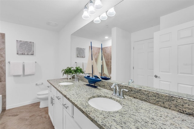 bathroom featuring toilet, tile patterned floors, and vanity