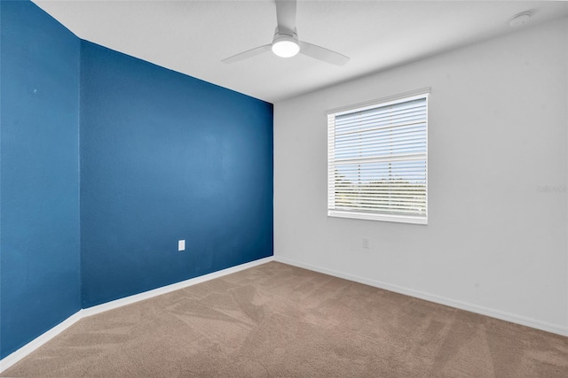 spare room featuring carpet floors and ceiling fan