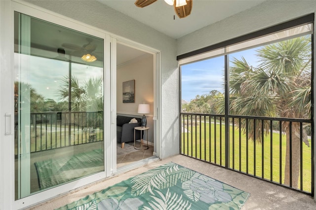 sunroom featuring ceiling fan