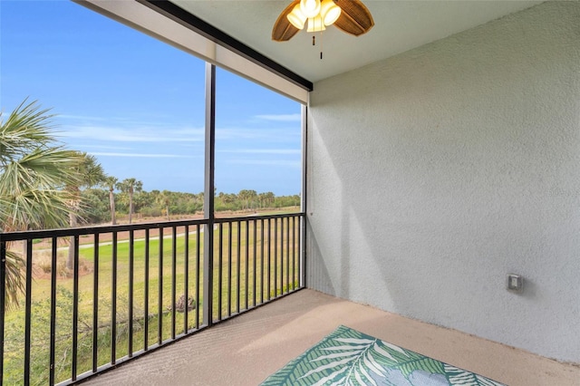 sunroom featuring ceiling fan