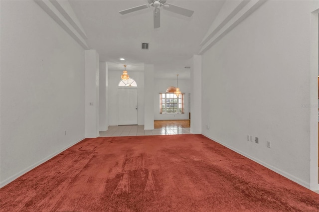 unfurnished living room featuring ceiling fan and light carpet