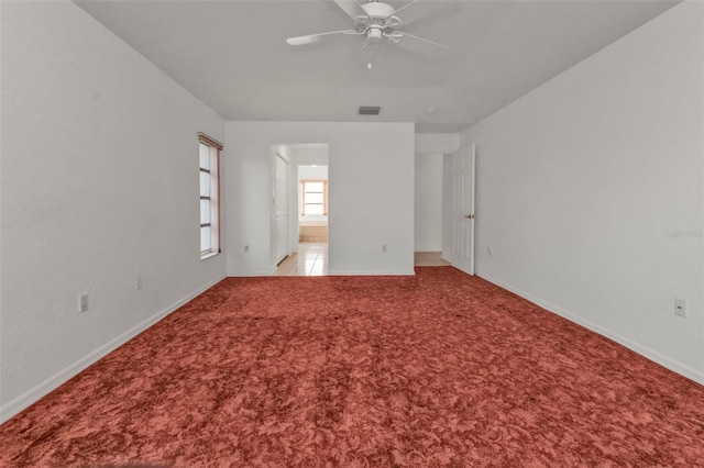 unfurnished room featuring light carpet and ceiling fan