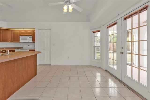 kitchen featuring ceiling fan, sink, white appliances, light tile patterned floors, and french doors