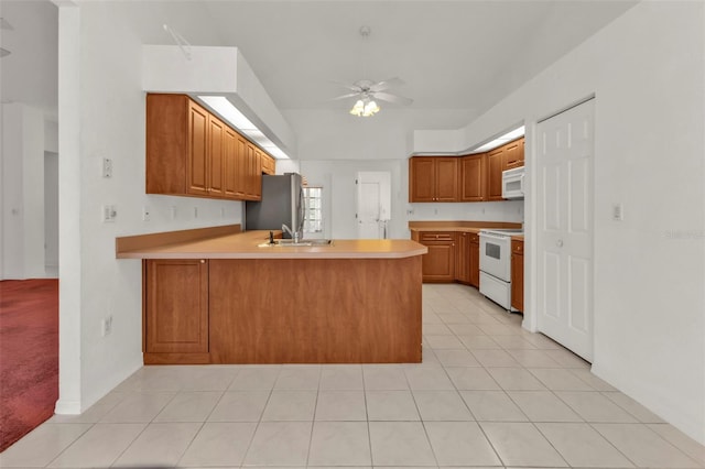 kitchen with ceiling fan, kitchen peninsula, light tile patterned flooring, and white appliances