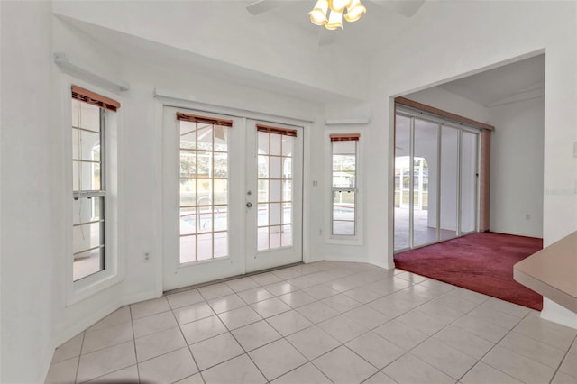 doorway featuring ceiling fan, light tile patterned floors, and french doors