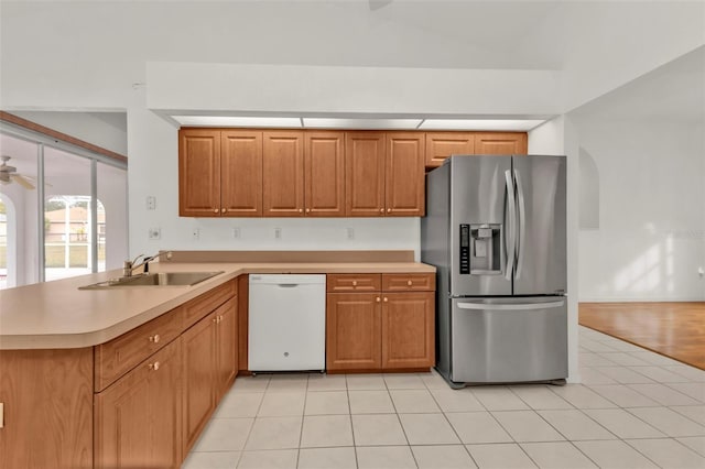 kitchen featuring dishwasher, kitchen peninsula, stainless steel refrigerator with ice dispenser, sink, and light tile patterned flooring