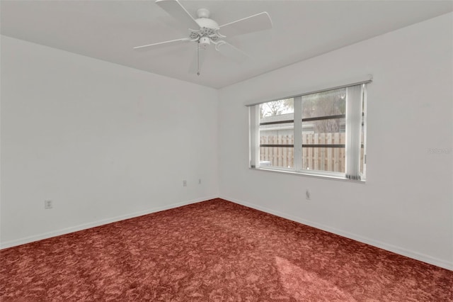 empty room with ceiling fan and carpet floors