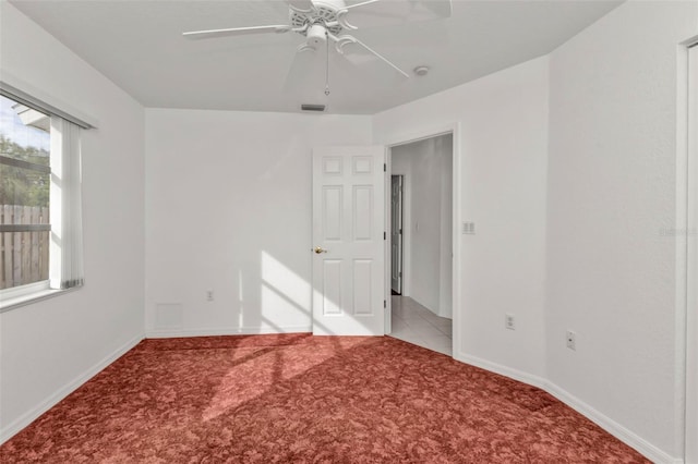 unfurnished room featuring ceiling fan and light carpet