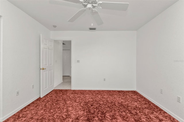 spare room featuring ceiling fan and light carpet