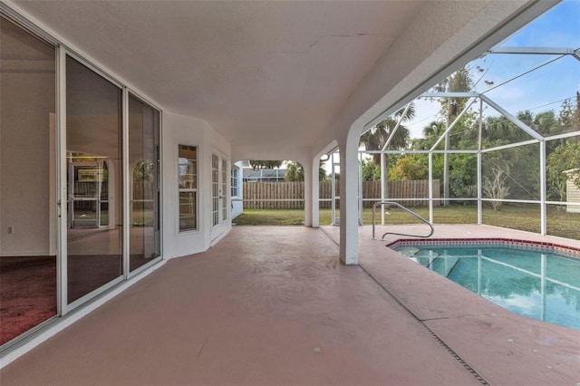 view of pool featuring a patio area and glass enclosure