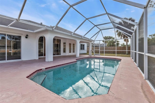 view of swimming pool with a lanai, french doors, and a patio