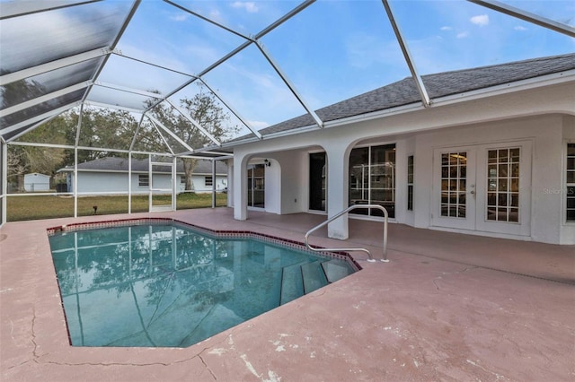 view of swimming pool featuring french doors, a patio area, and glass enclosure