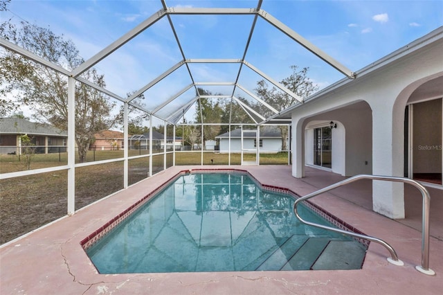 view of swimming pool featuring a patio area, a lanai, and a yard