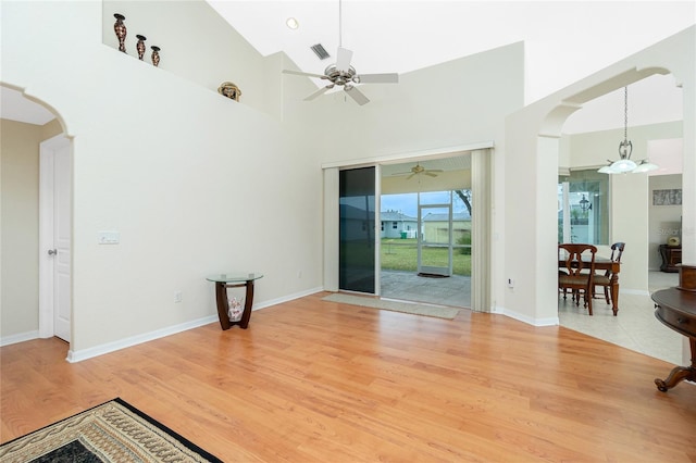 spare room featuring hardwood / wood-style flooring, ceiling fan, and high vaulted ceiling