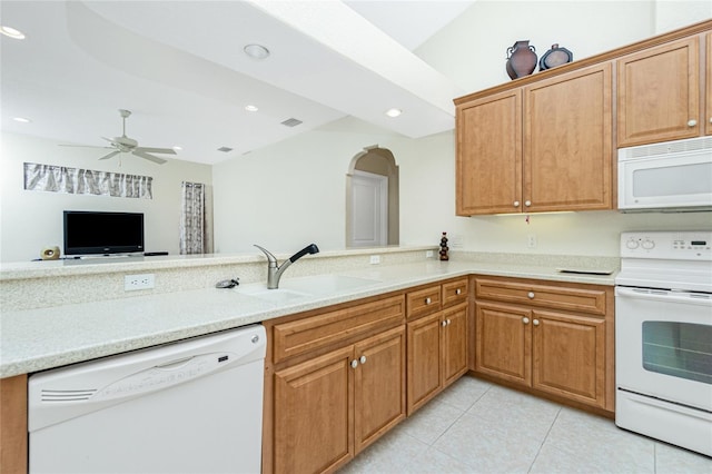 kitchen with sink, white appliances, light tile patterned floors, ceiling fan, and kitchen peninsula