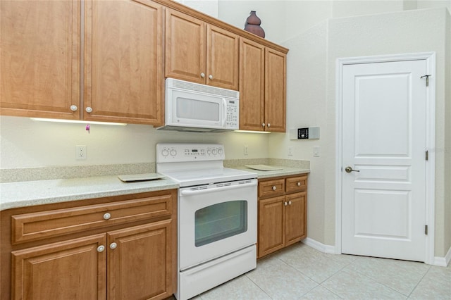 kitchen with light tile patterned floors and white appliances