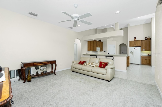 carpeted living room featuring ceiling fan