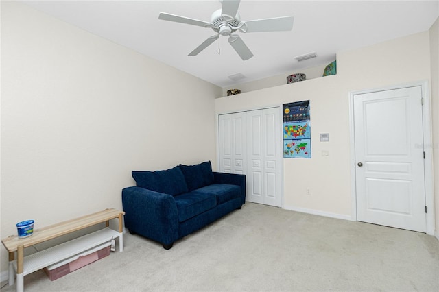 sitting room featuring light carpet and ceiling fan