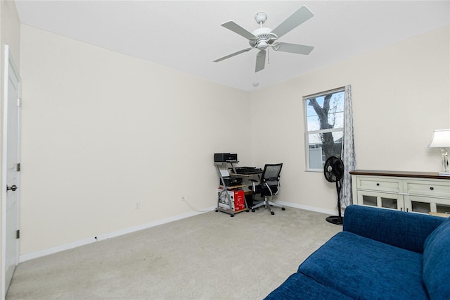 carpeted office space with ceiling fan