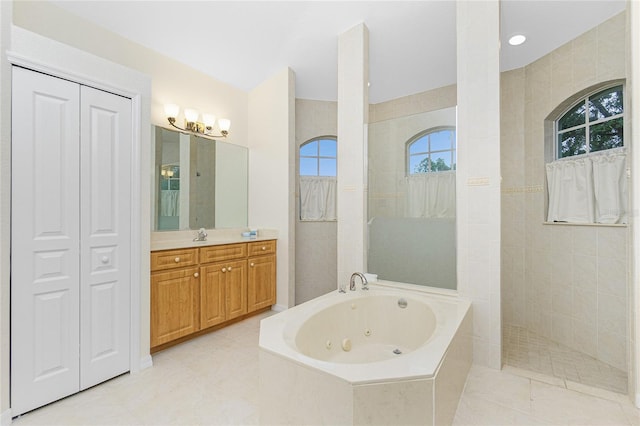 bathroom with tile patterned floors, vanity, and plus walk in shower