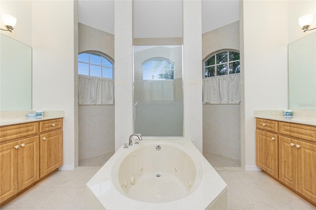 bathroom featuring tile patterned flooring, vanity, and independent shower and bath