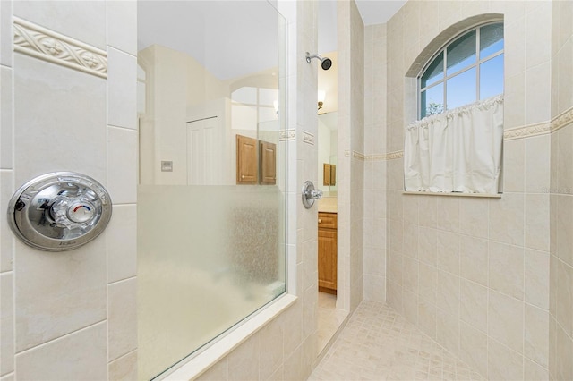 bathroom featuring vanity and a tile shower