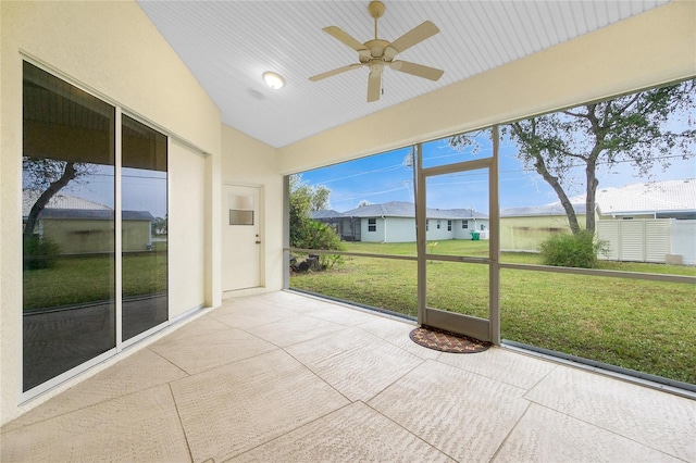 unfurnished sunroom with lofted ceiling and ceiling fan