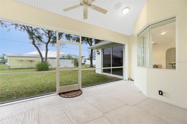 unfurnished sunroom featuring lofted ceiling and ceiling fan