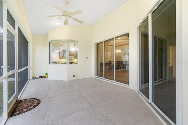 unfurnished sunroom featuring ceiling fan and lofted ceiling