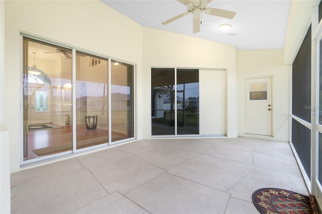 unfurnished sunroom featuring ceiling fan