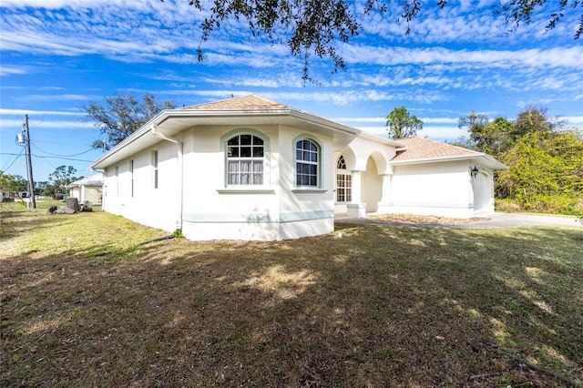 view of front of house with a garage and a front lawn