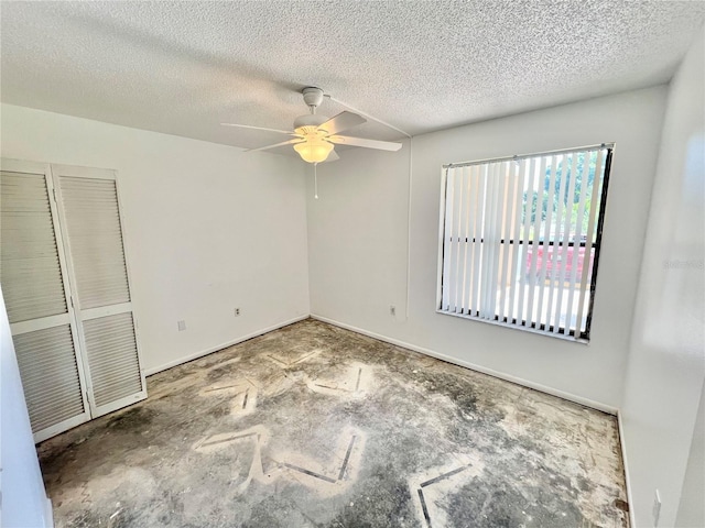 unfurnished bedroom with a textured ceiling and ceiling fan