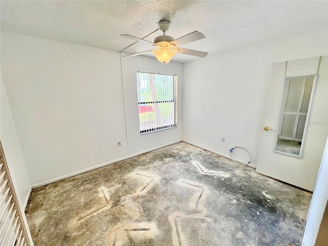 empty room with a textured ceiling and ceiling fan