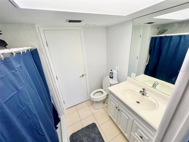 bathroom with vanity, tile patterned flooring, toilet, and curtained shower