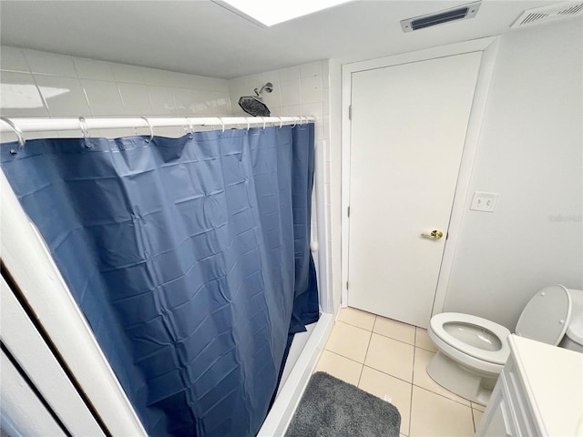 bathroom with walk in shower, tile patterned flooring, vanity, and toilet