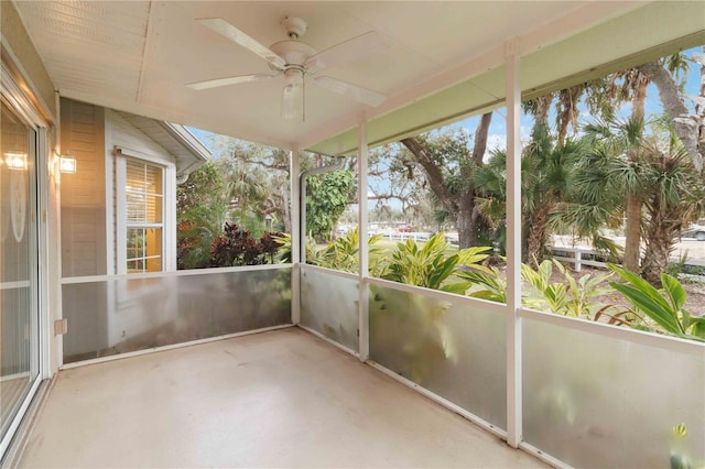 unfurnished sunroom with ceiling fan and a healthy amount of sunlight