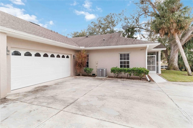 exterior space featuring a garage and central AC