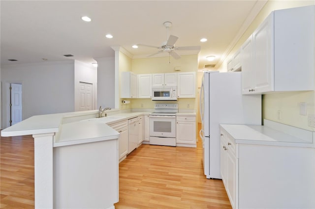 kitchen with white cabinetry, crown molding, kitchen peninsula, and white appliances