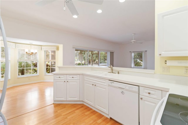 kitchen with decorative light fixtures, sink, white cabinetry, and dishwasher