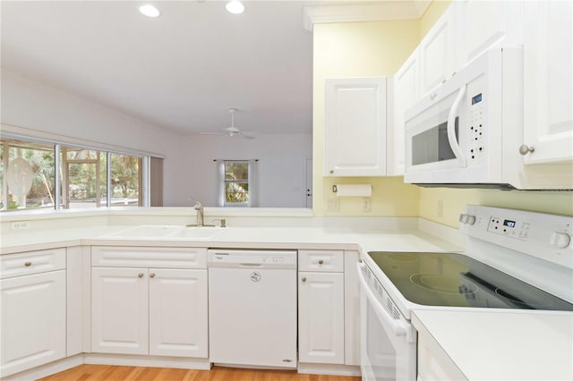 kitchen featuring white cabinetry, sink, white appliances, and ceiling fan