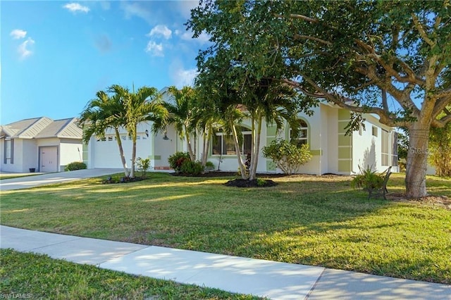 view of front of house with a front yard and a garage