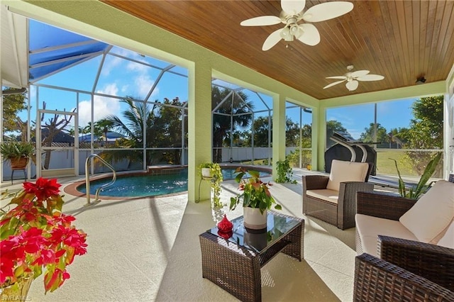 sunroom featuring ceiling fan, a swimming pool, and wooden ceiling