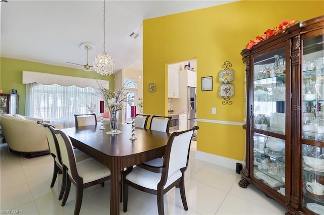 tiled dining space featuring a notable chandelier