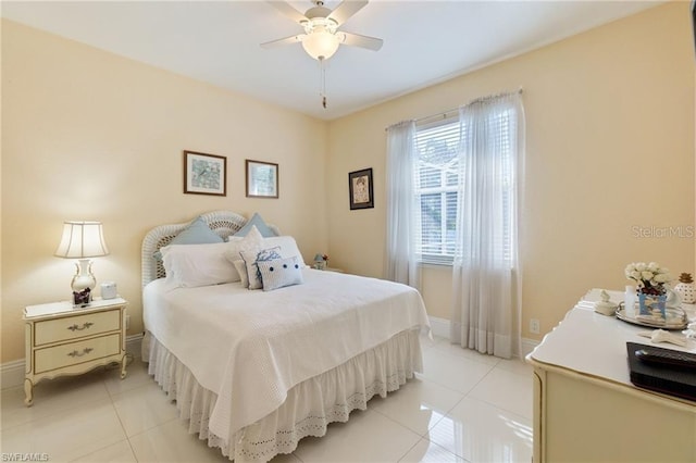 bedroom with ceiling fan and light tile patterned floors